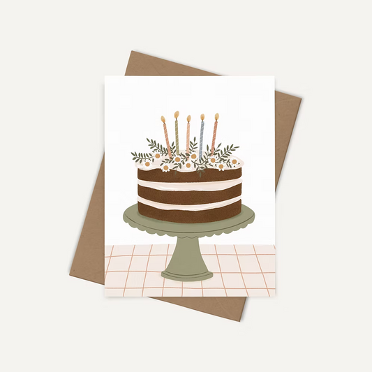 Offrir un mot de douceur avec une carte de souhaits illustrée par Joannie Houle, motif de gâteau d'anniversaire, style festif et minimaliste.