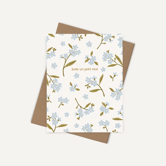 Offrir un mot de douceur avec une carte de souhaits illustrée par Joannie Houle, motif de fleurs bleues, style botanique minimaliste.